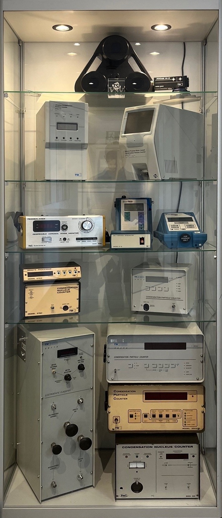 Legacy CPC particle counters in a glass cabinet